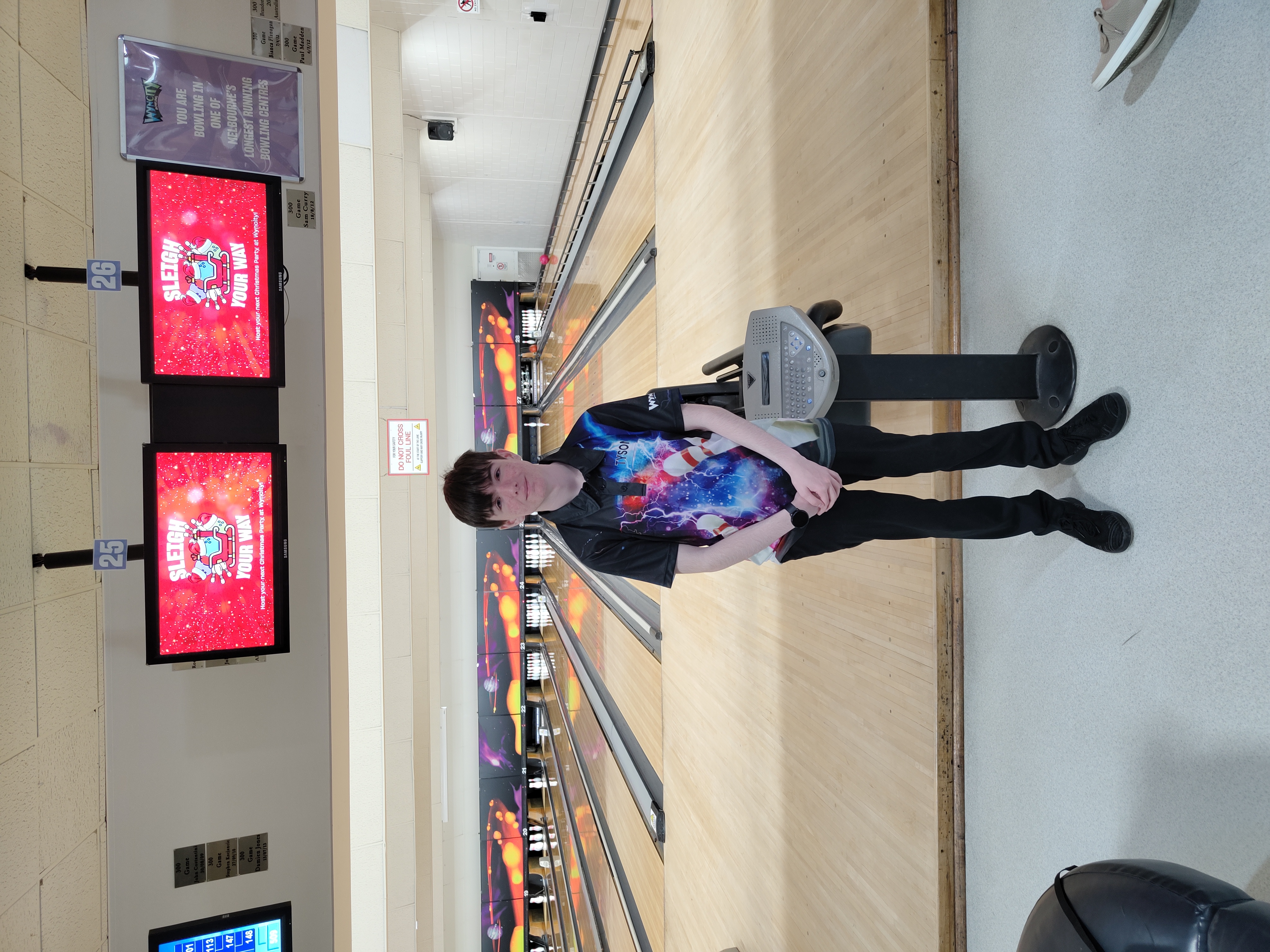 Tyson standing infront of bowling alley.